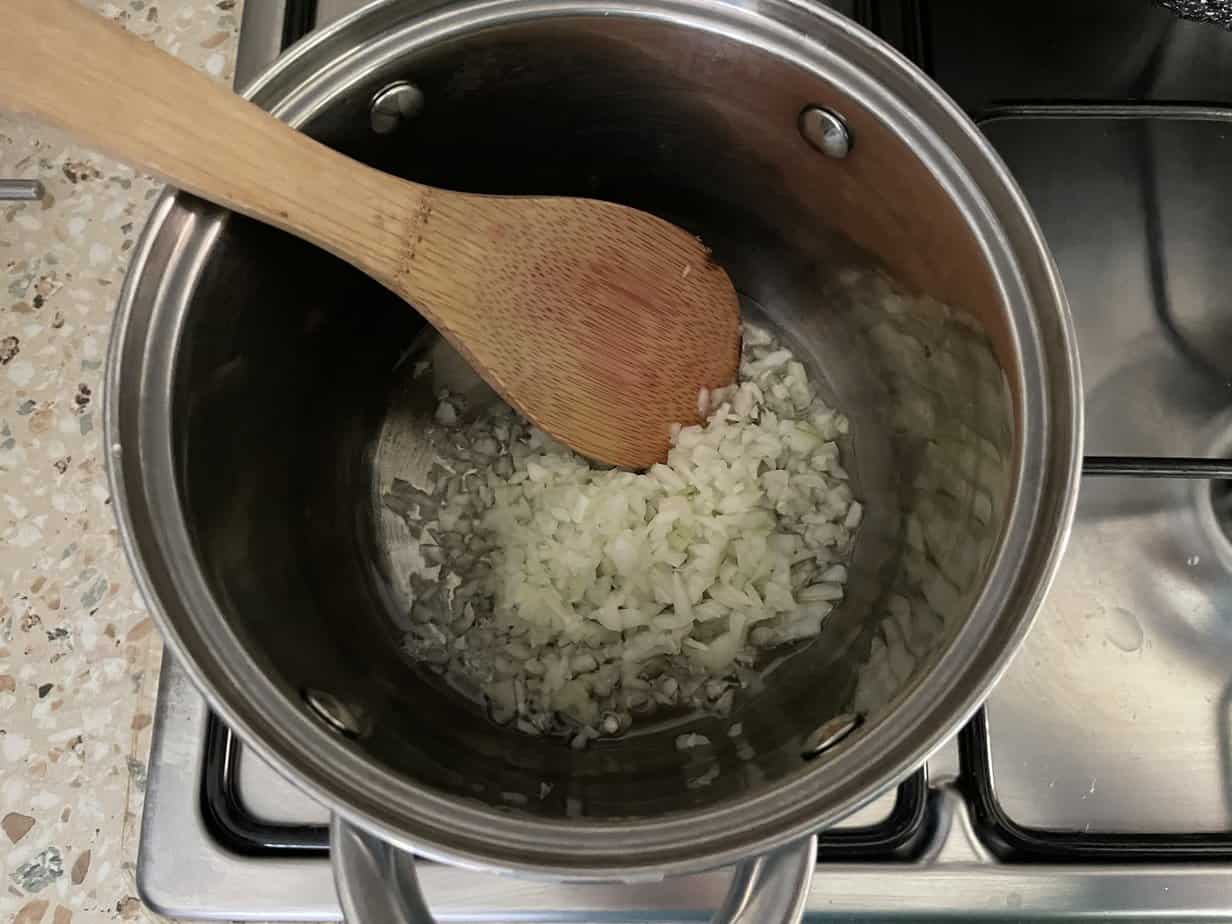 Polish Chanterelle Cream Sauce Recipe with onions and wooden spoon.