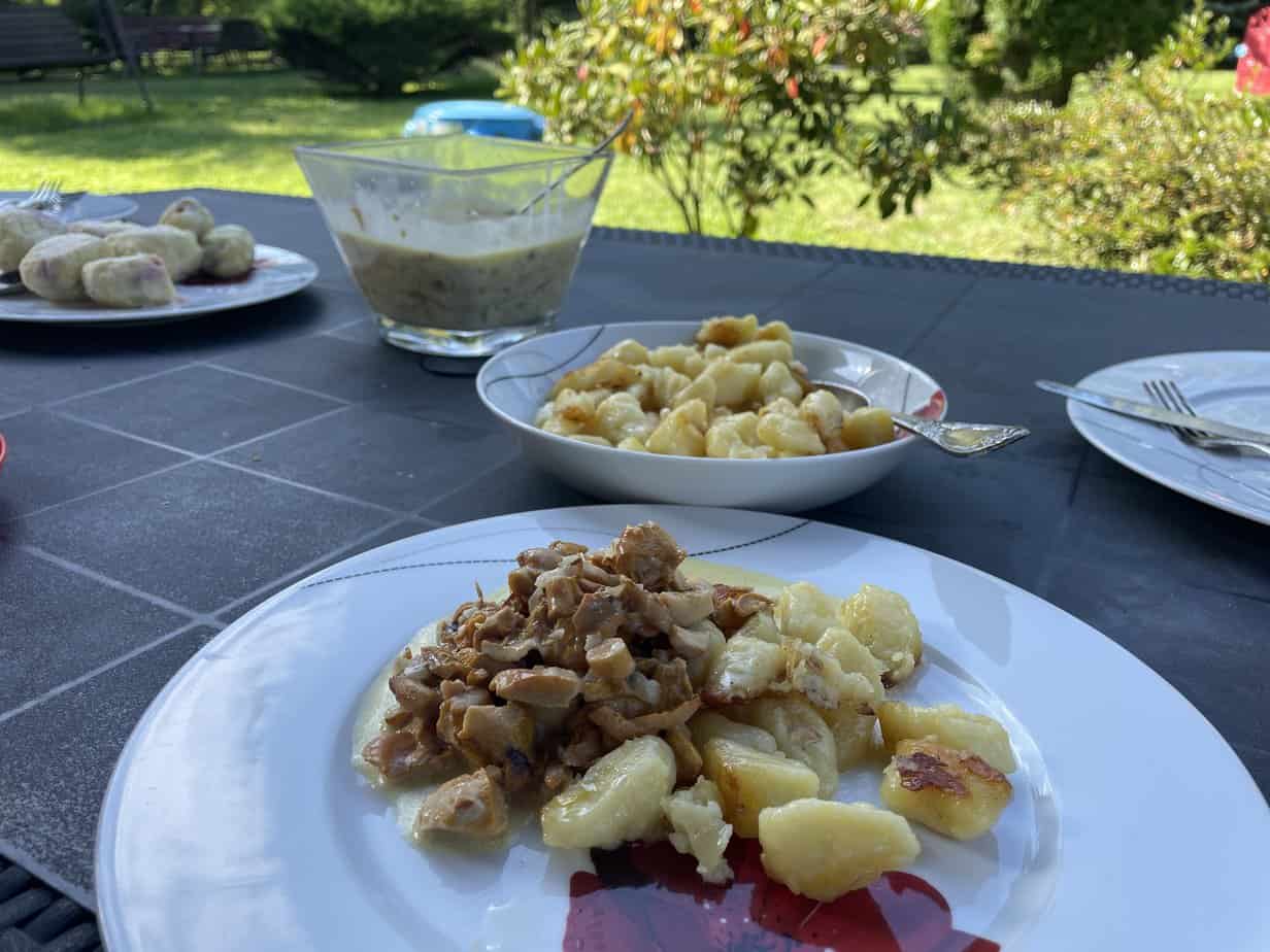 A table with plates of food on it showcasing a Polish Chanterelle Cream Sauce Recipe.