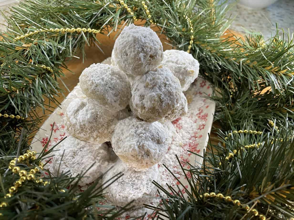 Polish snowball cookies after their second coating of powdered sugar.