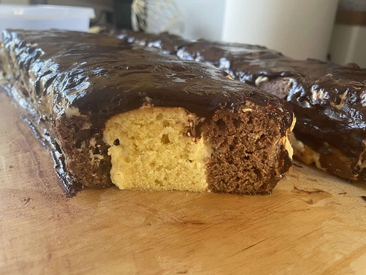 A homemade Metrowiec, partially cut, revealing a yellow sponge interior.