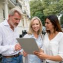 Real estate agent reviewing new home construction sale details with Minnesota homeowners