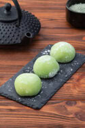 Homemade Matcha Ice Cream Recipe – A Taste Of Japan image 4 matcha mochi lined up on black chalk board with tea pot in the background Frosted Fusions