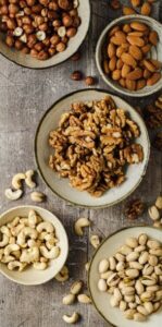 easy-homemade-brown-butter-pecan-ice-cream-image-3-cropped-selection-of-nuts-walnuts-hazelnuts-pistachios-and-almonds-on-a-wooden-surface-frosted-fusions