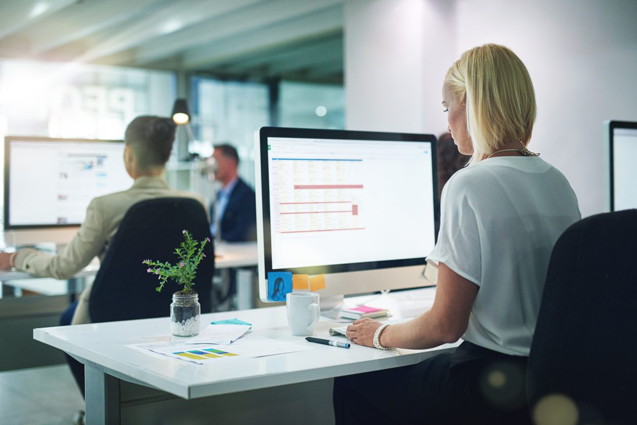 An image of a female real estate agent at desk