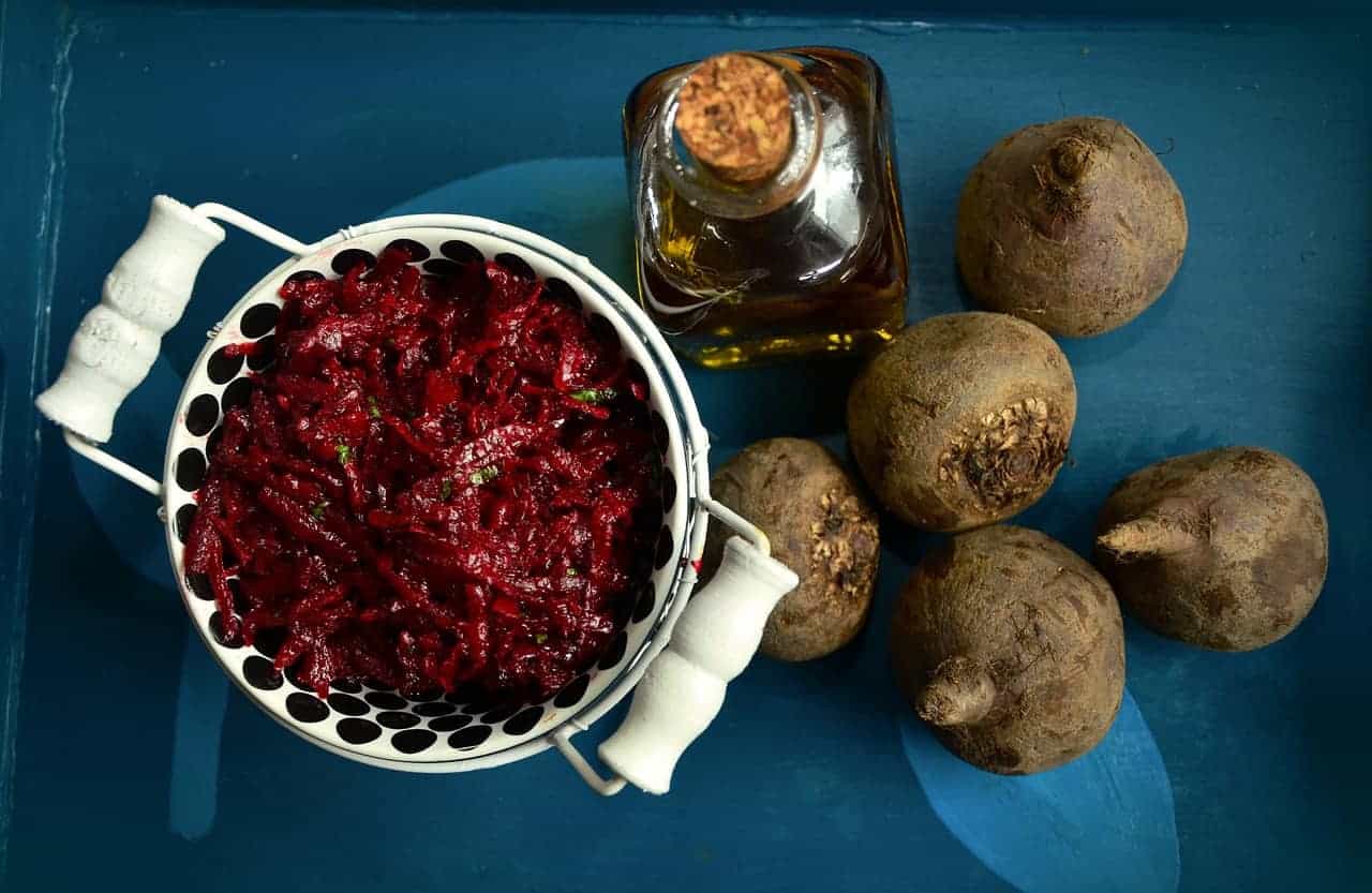 Buraczki in a bowl surrounded by beetroots.