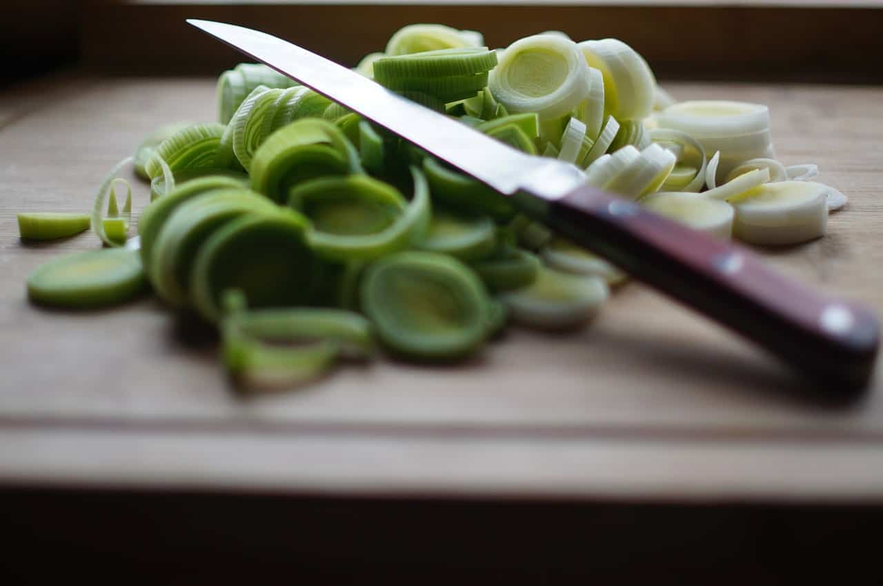Chopped leeks on a board.