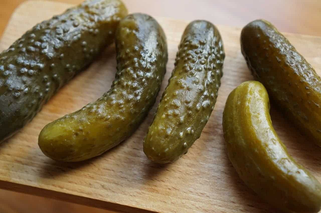 Polish pickles on a wooden cutting board.