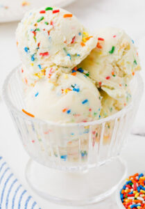 homemade-birthday-cake-ice-cream-recipe-image-2-scoops-of-birthday-cake-ice-cream-in-a-glass-dish-frosted-fusions