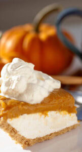 20-festive-winter-ice-cream-recipe-ideas-image-5-pumpkin-pie-with-ice-cream-and-pumpkin-in-the-background-frosted-fusions