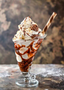 Ferrero-Rocher-Lovers-This-Homemade-Ice-Cream-Recipe-Is-For-You-Image-5-sundae-glass-filled-with-ferrero-rocher-ce-cream-topped-with-ferrero-rochers-Frosted-Fusions