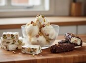 Homemade Nougat Ice Cream A Classic British Treat image 8 bowl of nougat ice cream with pieces of nougat chocolate coated nougat ice cream bars and nougat stacked Frosted Fusions