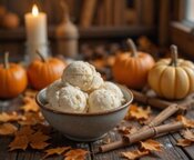 5-Delicious-Autumn-Inspired-Ice-Cream-Recipes-That-Taste-Like-A-Hug-Image-6-Bowl-of-ice-cream-on-rustic-wooden-table-with-pumpkins-cinnamon-sticks-and-golden-leaves-Frosted-Fusions