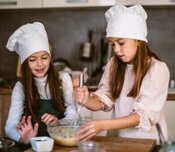Homemade Honeycomb Ice Cream A Sweet Treat For All Ages image 7 two children with chefs hats and baking equipment smiling whilst mixing frosted fusions homemade-honeycomb-ice-cream-a-sweet-treat-for-all-ages-image-7-two-children-with-chefs-hats-and-baking-equipment-smiling-whilst-mixing-frosted-fusions