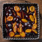 Homemade Caramelised Plum And Cardamom Ice Cream image 3 top view of plums in dish that have been caramelised frosted fusions Homemade Caramelised Plum And Cardamom Ice Cream image 3 top view of plums in dish that have been caramelised frosted fusions