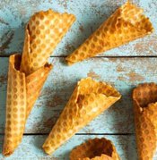 Ice Cream Waffle Cones For Every Diet From Gluten-Sensitive To Dairy Substitutes image 7 several waffle cones on blue wooden background frosted fusions