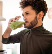Revitalise-And-Refresh-The-Ultimate-Detox-Green-Smoothie-image-6-man-drinking-a-green-smoothie-in-glass-frosted-fusions