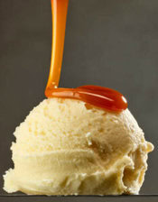 a-delicious-and-easy-homemade-butterscotch-ice-cream-image-3-single-scoop-of-vanilla-ice-cream-with-butterscotch-sauce-being-poured-over-the-top-frosted-fusions