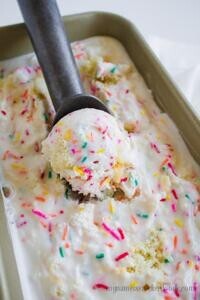 homemade-birthday-cake-ice-cream-recipe-image-1-tray-of-birthday-cake-ice-cream-with-ice-cream-scoop-frosted-fusions