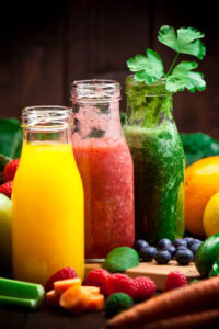 What-Smoothie-Is-Best-For-The-Immune-System-image-1-three-smoothies-in-amongst-a-selection-of-immune-boosting-ingredients-Frosted-Fusions