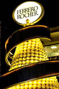 Ferrero-Rocher-Lovers-This-Homemade-Ice-Cream-Recipe-Is-For-You-Image-7-stack-of-ferrero-rocher-with-large-illuminated-sign-Frosted-Fusions