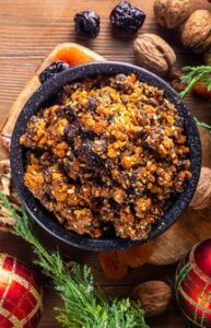 Festive-Fusions-Homemade-Brandy-and-Mince-Pie-Ice-Cream-image-5-bowl-of-mince-pie-filling-with-cinnamon-nutmeg-raisins-and-festive-decorations-scattered-around-rotated-frosted-fusions