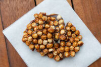 Ferrero-Rocher-Lovers-This-Homemade-Ice-Cream-Recipe-Is-For-You-Image-6-toasted-haelnuts-covered-in-caramel-syrup-white-background-Frosted-Fusions