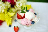No-Leap-Just-A-Scoop-Ice-Cream-Flavours-To-Spring-Into-March-image-10-glass-dish-of-ice-cream-with-fresh-berries-and-fresh-dlowers-to-the-side-Frosted-Fusions
