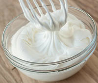 Homemade Ice Cream Hacks You Need To Know image 2 bowl of whipped cream with whisk showing stiff peaks frosted fusions