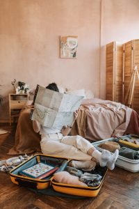 Femme derrière une carte pour étudier les bons plans pour éviter de dépenser trop en vacances