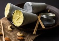 Rich-Creamy-Delicious-Homemade-Kulfi-Ice-Cream-A-Taste-Of-India-image-4-Kulfi-ice-cream-still-in-moulds-with-fresh-cashews-and-almonds-Frosted-Fusions