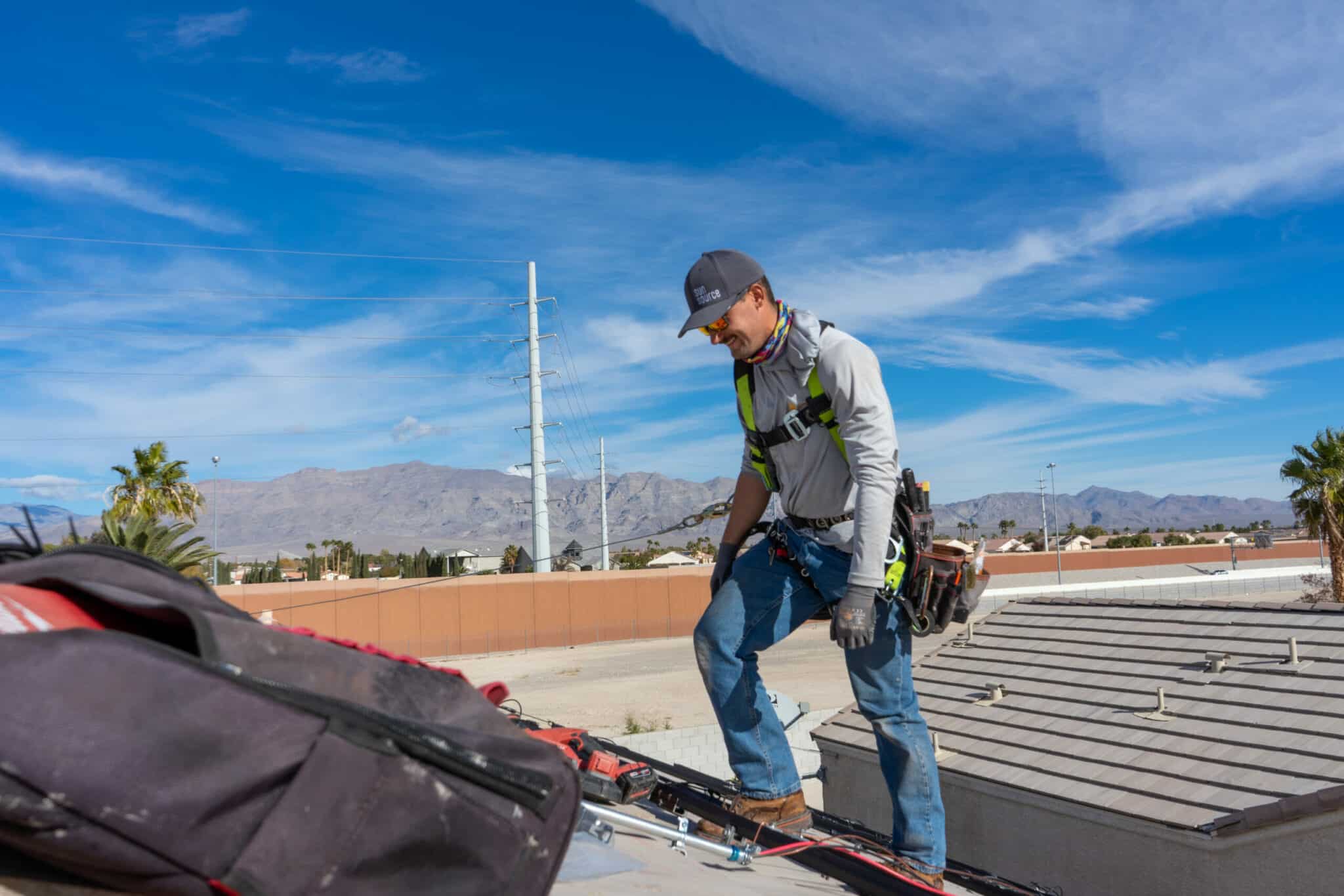 A solar installer working on a roof.