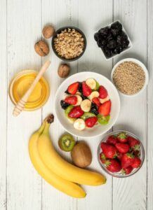 Vegan-And-Non-Dairy-Homemade-Ice-Cream-Using-Coconut-Milk-image-3-cropped-selection-of-fresh-fruits-seeds-nuts-and-honey-frosted-fusions