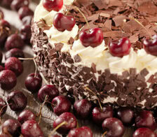 black-forest-ice-cream-cake-image-1-black-forest-gateau-with-fresh-cherries-scattered-frosted-fusions