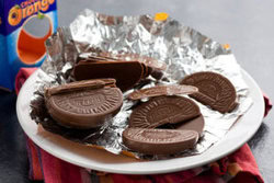 Taste-the-Nostalgia-Terrys-Chocolate-Orange-Homemade-Ice-Cream-image-1-Terrys-Chocolate-Orange-opened-with-segments-scattered-on-foil-and-white-plate-frosted-fusions
