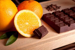 Taste-the-Nostalgia-Terrys-Chocolate-Orange-Homemade-Ice-Cream-image-3-oranges-whole-and-halved-with-leaves-and-a-slab-of-chocolate-on-wooden-board-frosted-fusions