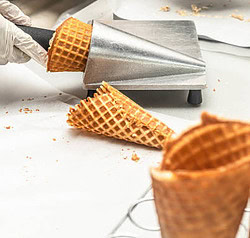 mastering-the-art-make-homemade-ice-cream-cones-image-2-ice-cream-cones-being-rolled-with-cone-shaper-frosted-fusions
