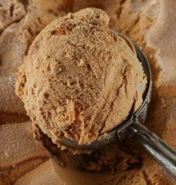 Homemade-Cinnamon-Churros-Ice-Cream-Spice-and-Crispy-Comfort-image-4-scoop-of-Cinnamon-ice-cream-with-cinnamon-dusted-over-frosted-fusions
