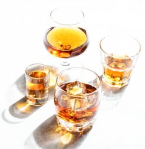 A-Not-So-Hot-Toddy-Homemade-Honey-Lemon-Ginger-Ice-Cream-image-4-glass-of-whickey-brandy-bourbon-and-rum-with-white-background-Frosted-Fusions