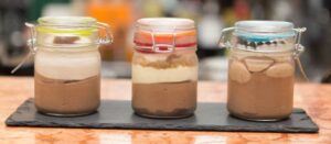 Learn-To-Make-Homemade-Ice-Cream-A-Beginners-Guide-image-13-three-jars-lined-up-with-ice-cream-layers-frosted-fusions