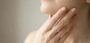 hand touching jawline natural light