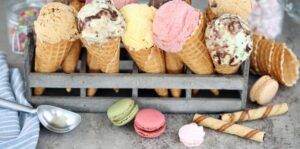 Learn-To-Make-Homemade-Ice-Cream-A-Beginners-Guide-image-10-row-of-ice-cream-cones-with-variety-of-different-ice-cream-scoops-in-rack-frosted-fusions