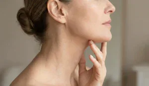 woman touching jawline neck profile