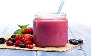 new-year-fresh-vibes-nourish-your-body-with-healthful-smoothies-image-4-pink-smoothies-in-glass-jar-with-straw-with-fresh-berries-scattered-frosted-fusions