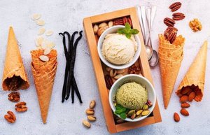 The Ice Cream And Sugar Debate image 10 top view ice cream cones with nuts and vanilla pods with 2 bowls of ice cream and silver spoons frosted fusions
