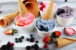The Ice Cream And Sugar Debate image 9 tubs of fresh fruity ice cream with fresh fruits and ice cream cones scattered frosted fusions