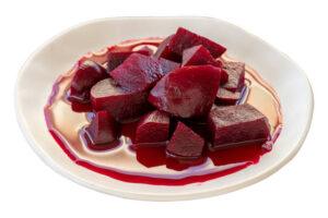 Homemade-Beetroot-Ice-Cream-Naturally-Sweet-Vibrant-image-8-white-dish-with-vibrant-beetroot-pieces-and-beeteroot-juice-white-background-frosted-fusions