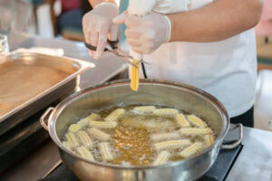 Homemade Cinnamon & Churros Ice Cream Spice and Crispy Comfort image 5 Churros cooking in oil frosted fusions