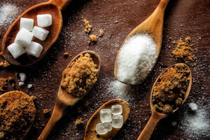 The Ice Cream And Sugar Debate image 6 different types and coloured sugar on wooden spoons lined up frosted fusions