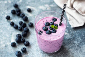 What-Smoothie-Is-Best-For-The-Immune-System-image-2-blueberry-smoothie-with-fresh-blueberries-scattered-Frosted-Fusions