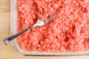 Watermelon-Sorbet-Granita-–-A-Refreshing-Taste-Of-Spring-image-1-watermelon-granite-in-tray-wirh-fork-rotated-Frosted-Fusions